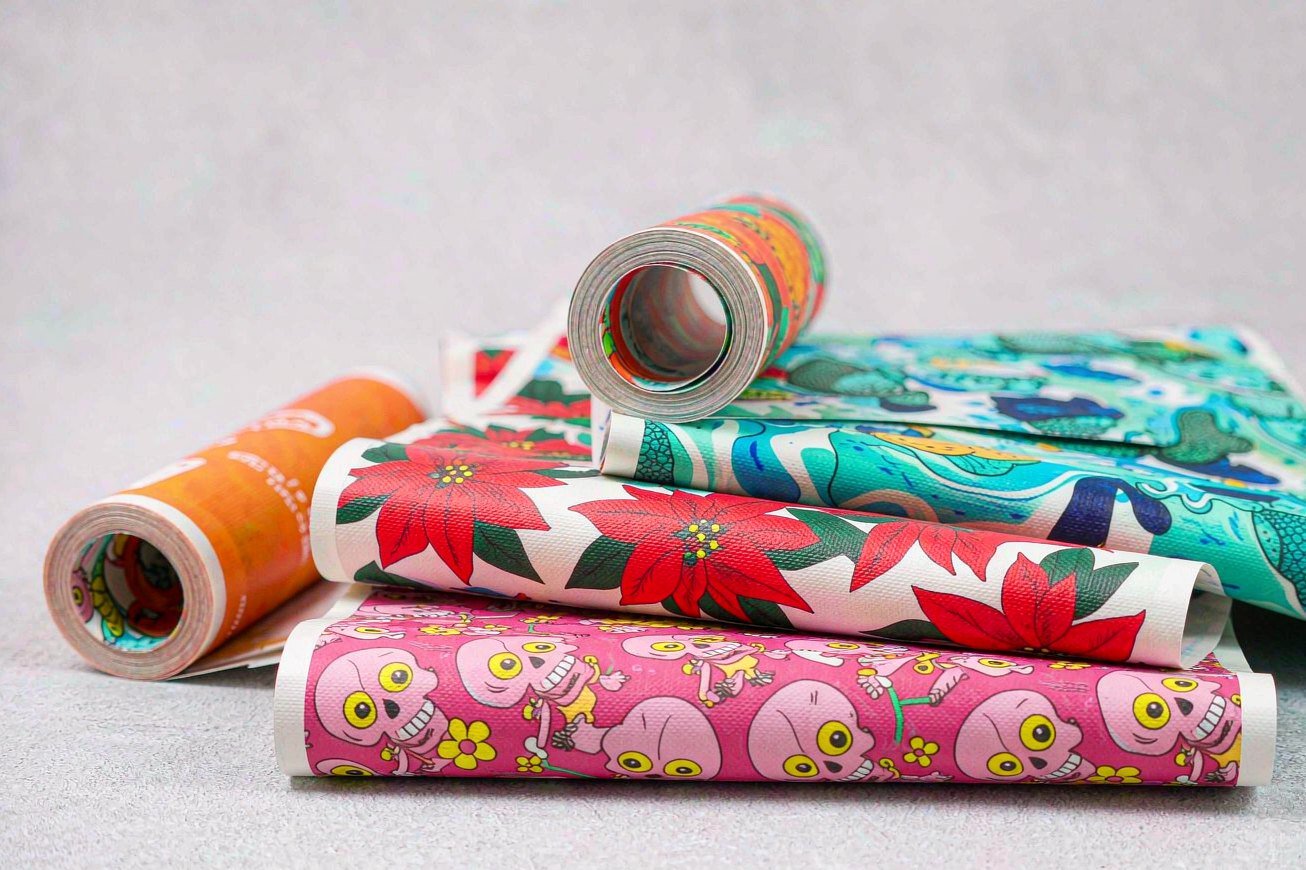 Stack of printed transfer film sheets and rolls in different patterns